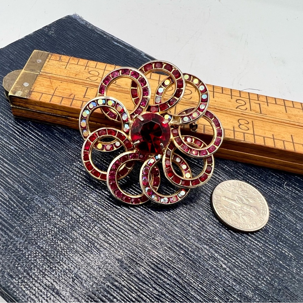 Vintage gold tone loopy circles brooch pin with red AB rhinestones- one missing